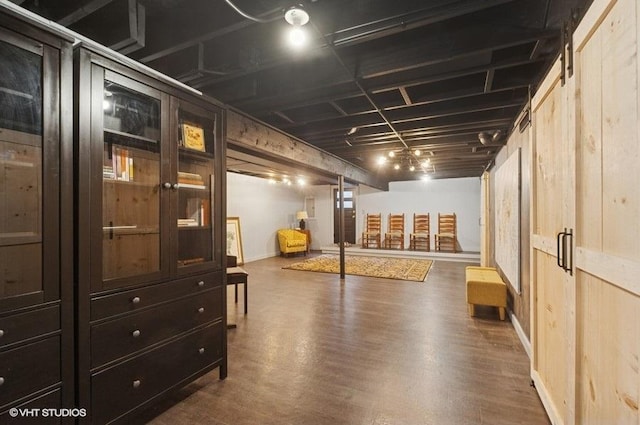 finished below grade area with baseboards and dark wood-type flooring