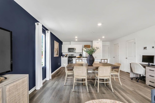 dining area with recessed lighting, baseboards, and wood finished floors