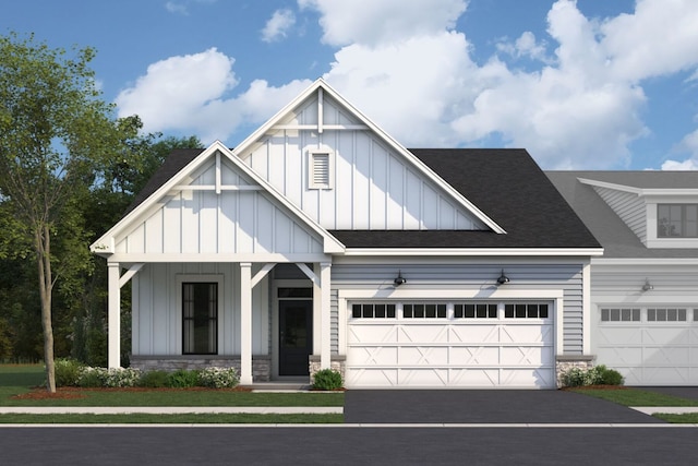 view of front of home featuring aphalt driveway, a garage, board and batten siding, and a shingled roof