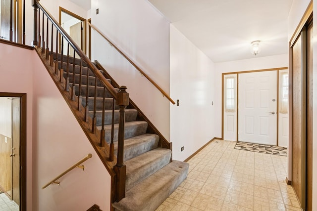 entryway with light floors and baseboards