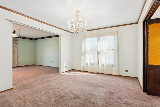 carpeted spare room featuring a chandelier, baseboards, and ornamental molding