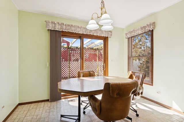 dining room with baseboards and an inviting chandelier