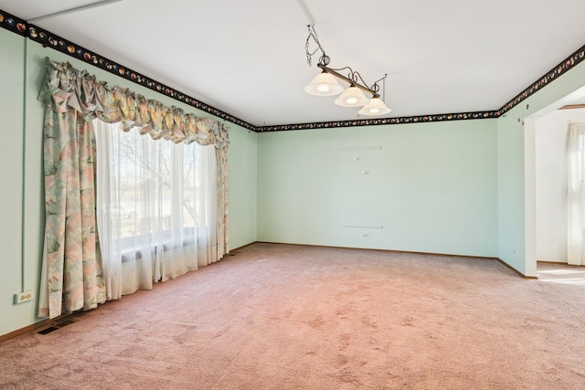 unfurnished room with visible vents, baseboards, and carpet