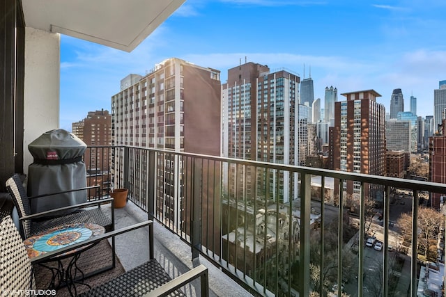 balcony with area for grilling and a city view