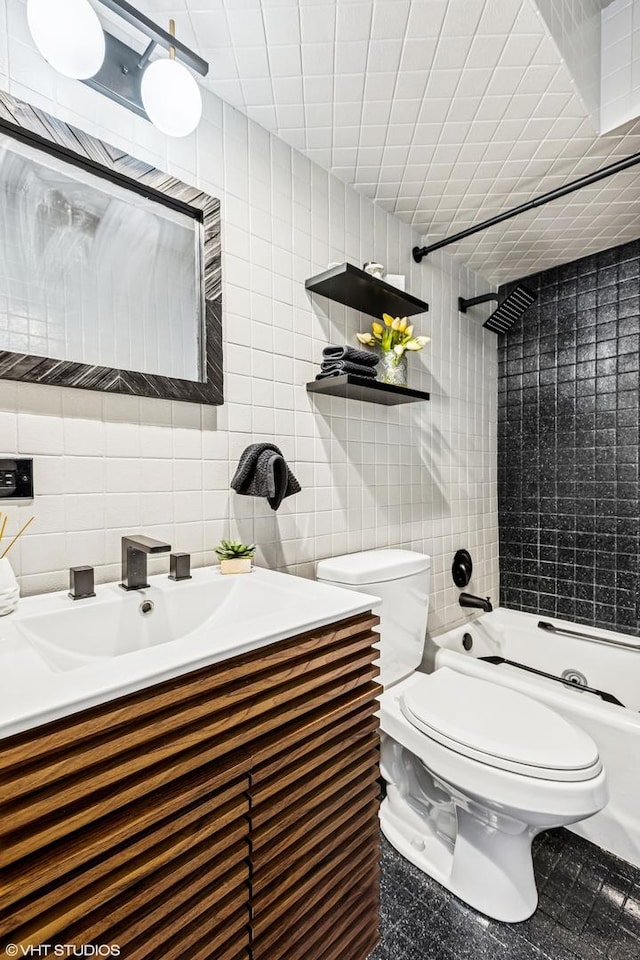 full bathroom with backsplash, shower / washtub combination, toilet, vanity, and tile walls