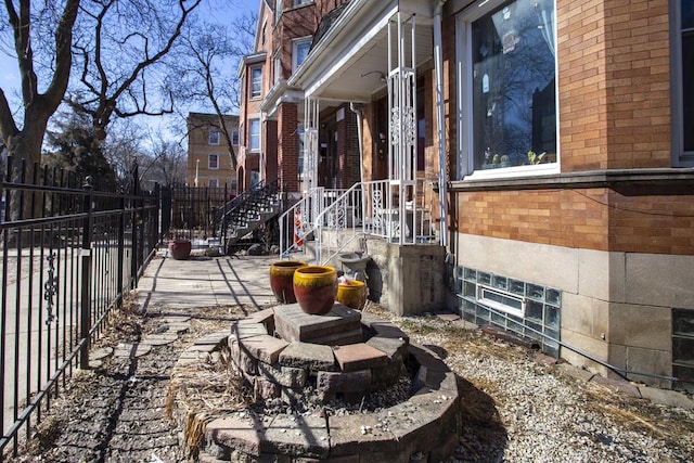 view of home's exterior with fence and brick siding