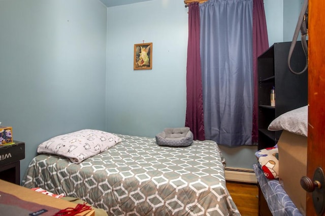 2652 W 22nd Pl, Chicago, IL 60608 - bedroom featuring a baseboard heating unit and wood finished floors