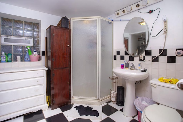 2652 W 22nd Pl, Chicago, IL 60608 - bathroom featuring tile patterned floors, toilet, tile walls, and a shower stall