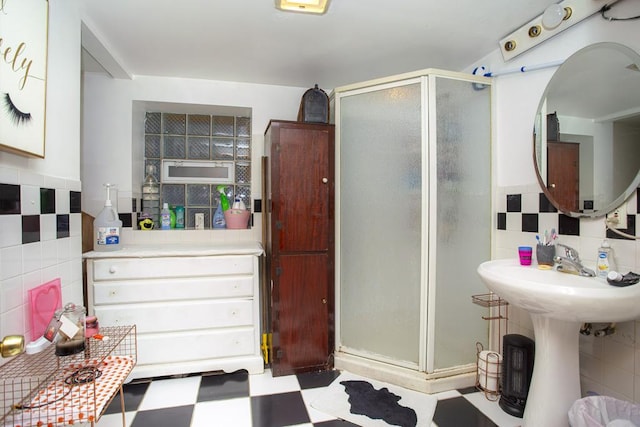 2652 W 22nd Pl, Chicago, IL 60608 - bathroom featuring tile patterned floors, a shower stall, and tile walls