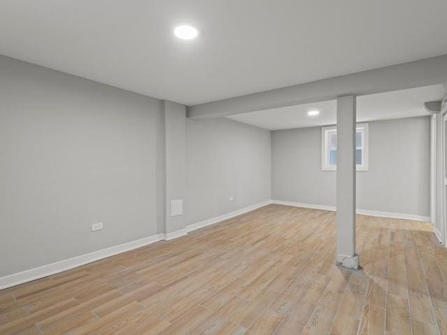 basement featuring light wood-type flooring and baseboards