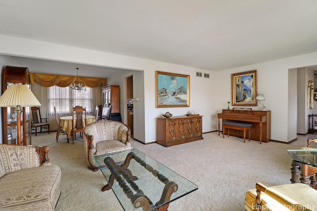 living room featuring visible vents, baseboards, carpet, and a chandelier