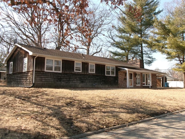 ranch-style home with a chimney