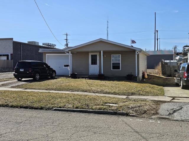 view of front facade with driveway, a front yard, and an attached garage