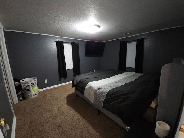 carpeted bedroom with a textured ceiling, crown molding, baseboards, and a textured wall