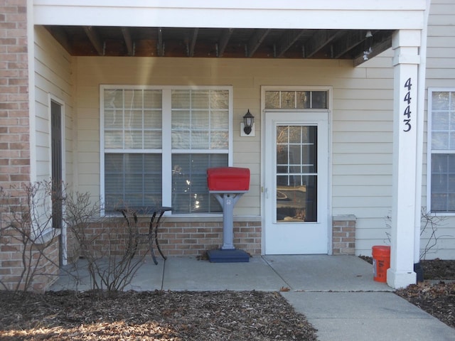 view of exterior entry with brick siding