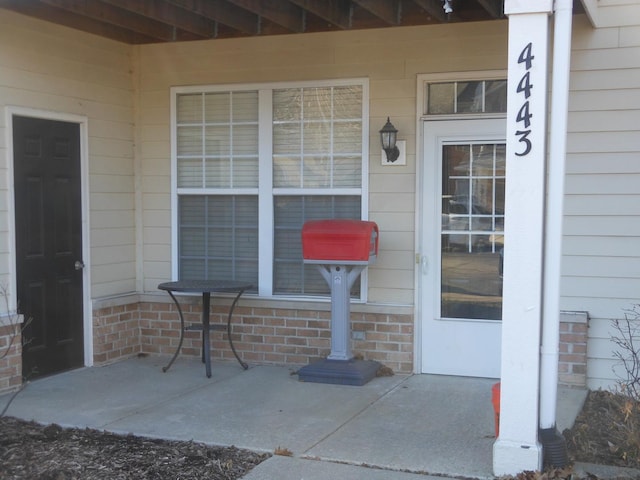 entrance to property featuring brick siding