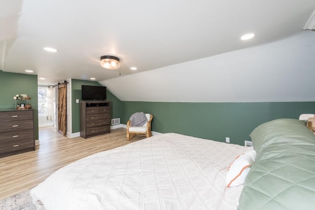 bedroom with lofted ceiling, recessed lighting, baseboards, and light wood finished floors