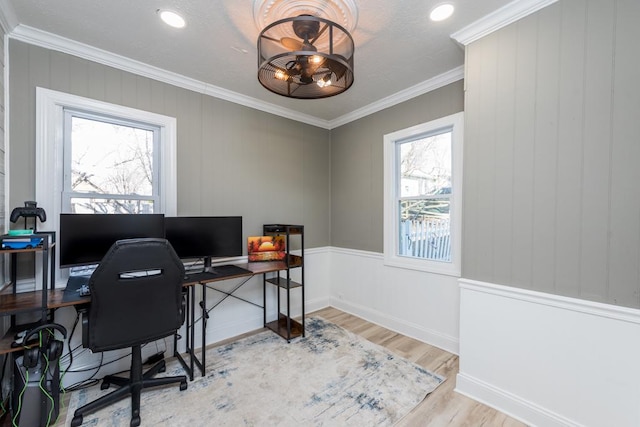 office space featuring ceiling fan, crown molding, baseboards, and wood finished floors