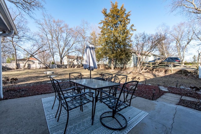 view of patio featuring outdoor dining space and fence