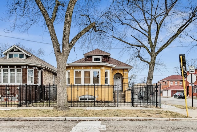 view of front of property featuring a fenced front yard and brick siding