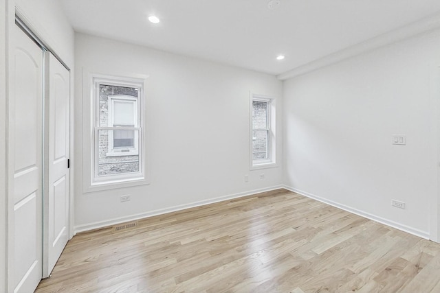 unfurnished bedroom featuring visible vents, recessed lighting, light wood-type flooring, and baseboards