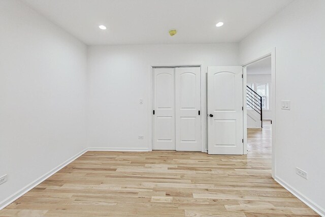 empty room featuring recessed lighting, light wood-style flooring, and baseboards