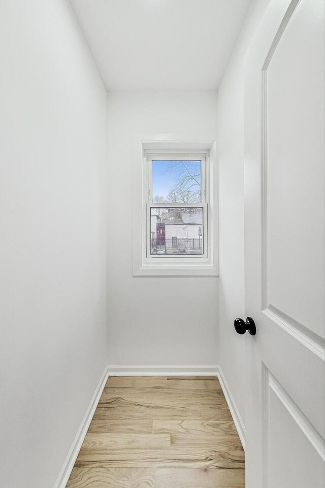 unfurnished room featuring light wood-style flooring and baseboards