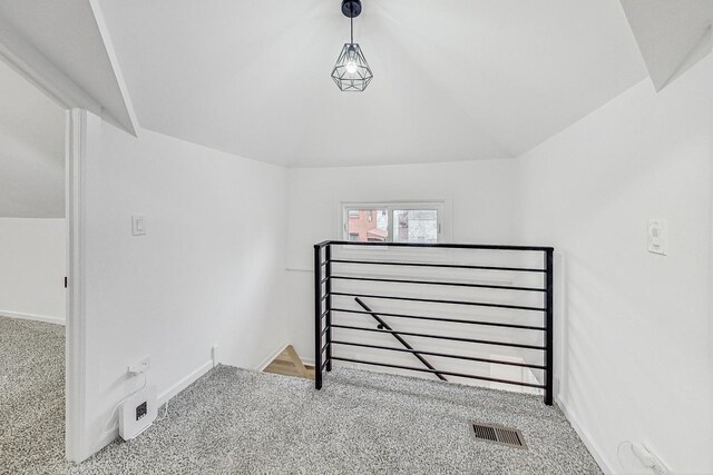 interior space featuring visible vents, baseboards, and vaulted ceiling