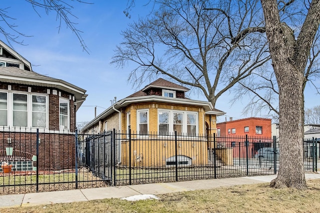 view of front of house featuring a fenced front yard and brick siding