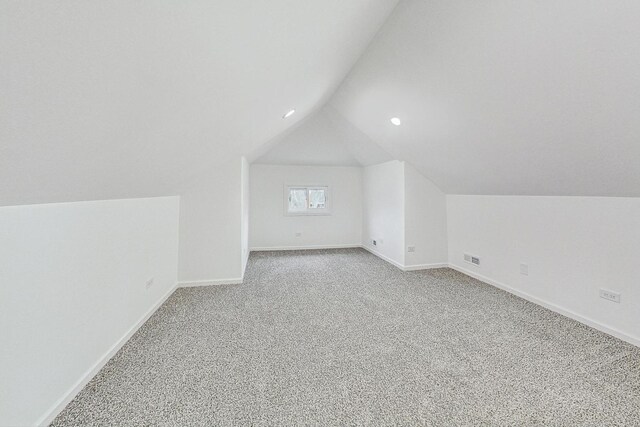 bonus room featuring baseboards, carpet flooring, and vaulted ceiling