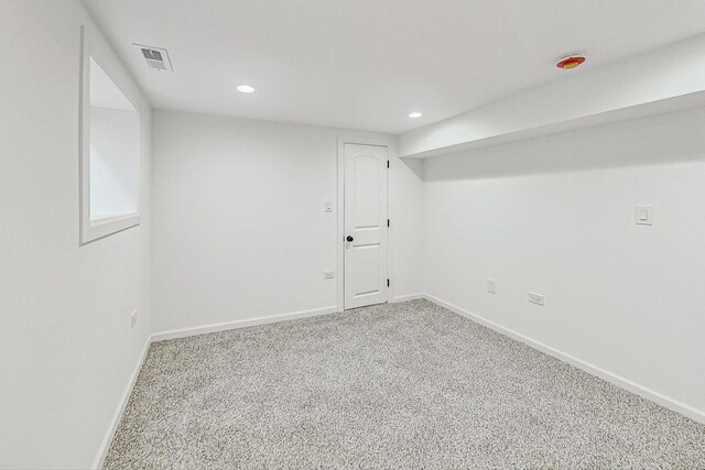 finished below grade area featuring visible vents, recessed lighting, baseboards, and carpet floors