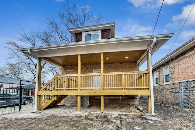 exterior space featuring brick siding and fence