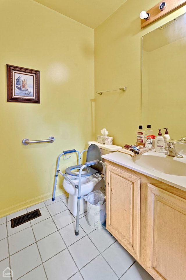 bathroom featuring tile patterned flooring, toilet, vanity, and visible vents