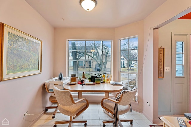 dining area featuring light tile patterned flooring and baseboards