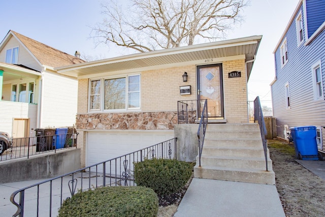 view of front of property with brick siding, stone siding, an attached garage, and concrete driveway