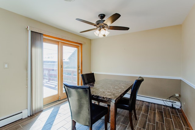 dining space with wood finish floors, a ceiling fan, and a baseboard radiator