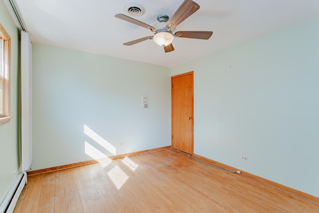 unfurnished room with visible vents, a baseboard heating unit, light wood-style floors, baseboards, and ceiling fan