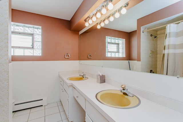 full bathroom featuring a baseboard heating unit, tile patterned flooring, a wealth of natural light, and a sink