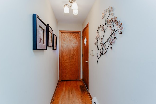 hall with baseboards and light wood-style flooring