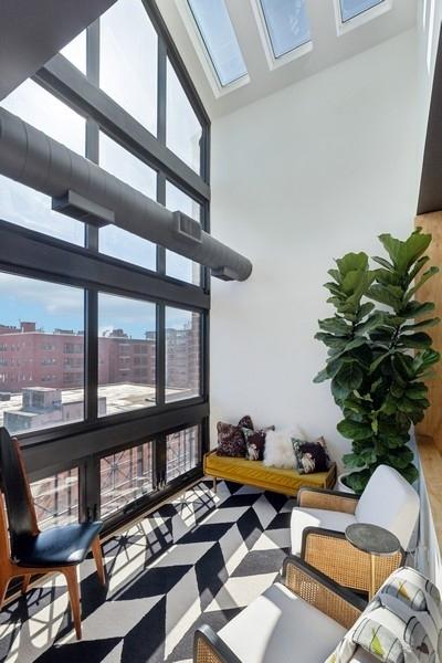 sunroom / solarium with a view of city and a skylight