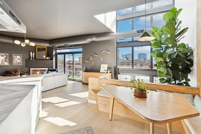 dining area featuring a notable chandelier, a city view, and wood finished floors