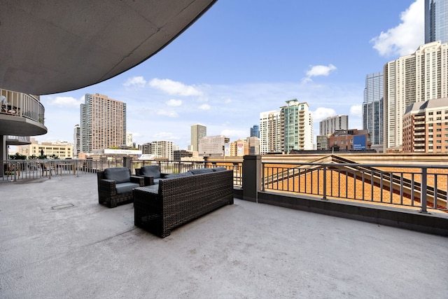 view of patio featuring a balcony and a view of city