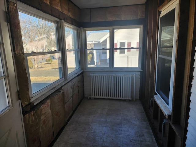 unfurnished sunroom with radiator