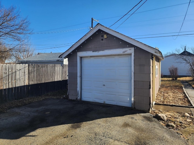 detached garage with fence and driveway