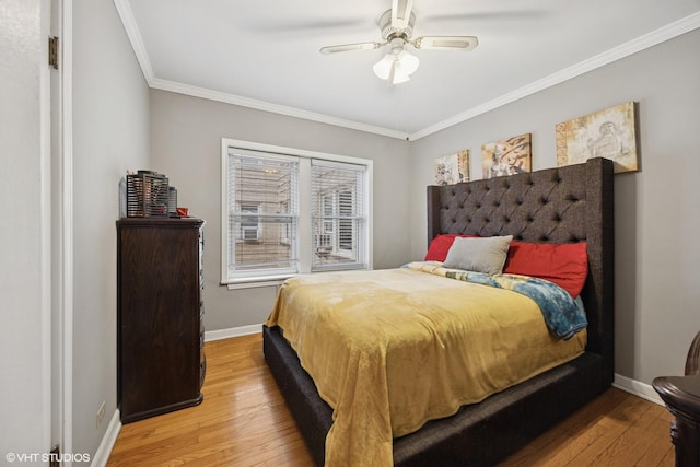 bedroom featuring ceiling fan, crown molding, baseboards, and wood-type flooring