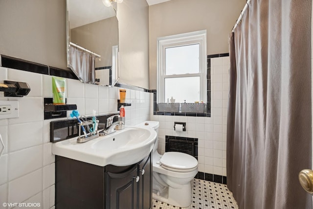 bathroom featuring a shower with shower curtain, toilet, tile walls, and vanity