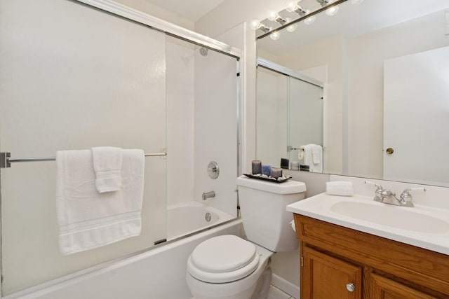 bathroom featuring toilet, vanity, and shower / bath combination with glass door