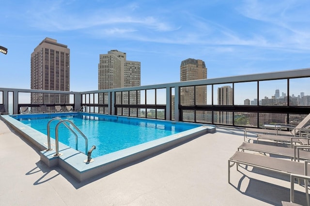 community pool featuring a patio and a view of city