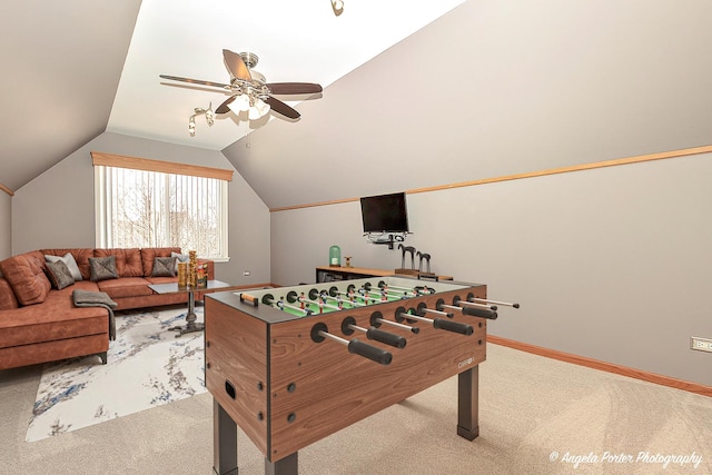 recreation room featuring baseboards, ceiling fan, carpet flooring, and vaulted ceiling