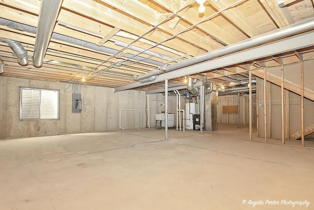 basement featuring heating unit and electric panel